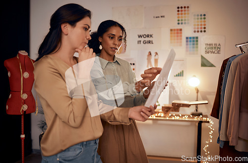 Image of Designers, fashion sketch and women have conversation, planning runway show and in work studio. Young females, artist and entrepreneur with paper, creative and communication for business and startup.