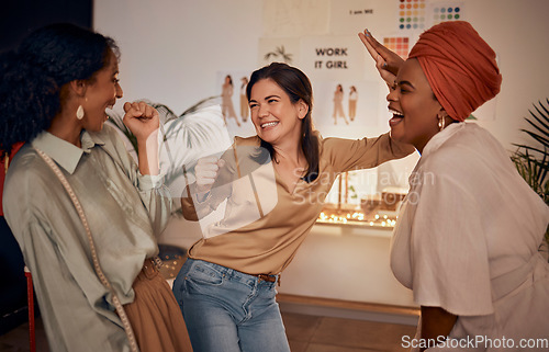 Image of Fashion designer, high five or success in teamwork collaboration, partnership store deal or sales growth in manufacturing workshop. Smile, happy or excited creative women in night clothing boutique