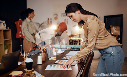 Image of Fashion, workshop and manufacturing women at night for small business, startup production or retail management of color choice. Textile industry, clothes supplier and people at desk in team planning