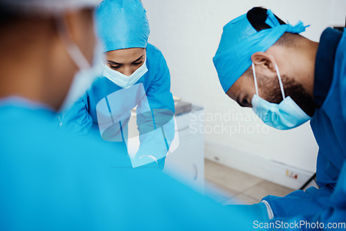Image of Covid, healthcare and surgery doctors in hospital for professional operation of patient. Focus, surgeons and medical people in theater with surgical face mask for protection and hygiene.
