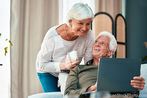 Image of Senior couple, laptop and happy at. home on lounge sofa talking and reading online for online shopping, social media or savings on banking website. Old man and woman together with coffee and wifi