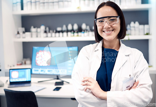 Image of Portrait, laboratory and Asian woman crossed arms, research and scientific methods for healthcare or cure. Computer, female researcher or medical professional for innovation, lab equipment and expert