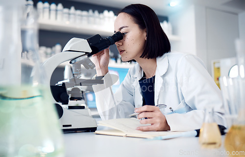 Image of Science, microscope and writing with a doctor woman doing research in her laboratory for innovation. Healthcare, zoom and notebook with a female scientist working in a lab for medical development