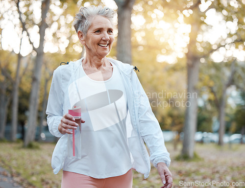 Image of Fitness, nature and senior woman with water bottle for wellness, hydration and minerals for walking in park. Health, retirement and elderly female doing workout, exercise and cardio training outdoors