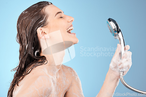 Image of Woman singing in shower, beauty and shower head with hygiene and hair care, cleaning body and girl profile for washing. Skincare, soap foam and happy with wellness and grooming with blue background.