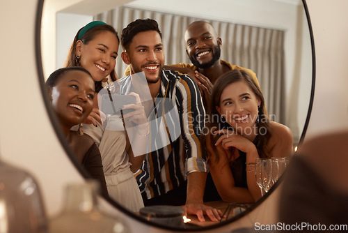 Image of Group of friends, phone and mirror selfie for party, celebration or New Years together. Young people reflection, diversity or smartphone to connect, smile or social gathering to enjoy dinner or relax