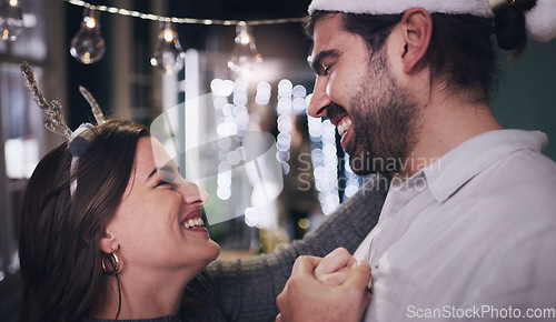 Image of Couple, christmas and dancing with love, care and affection while at a christmas party to celebrate. Loving, caring boyfriend and girlfriend dance during a festive season or xmas celebration