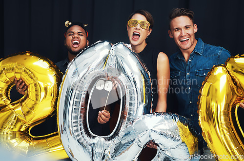 Image of New year, happy and friends portrait with balloons at a social celebration in a event photobooth. Excited, smile and happiness party of people ready to celebrate a holiday with cheering at night