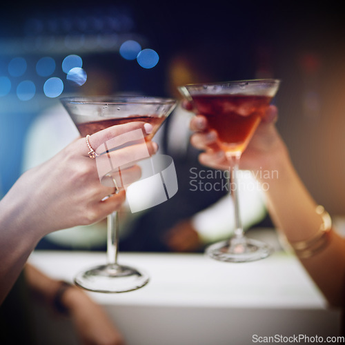 Image of Hands, cocktail and party with friends drinking together in a nightclub for a new year celebration. Glass, toast and event with a female and friend celebrating with a cheers in a music club or disco