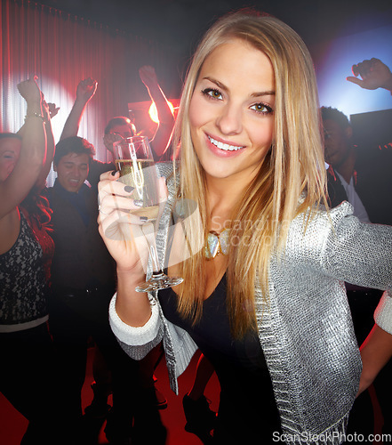 Image of Night club, party and woman with champagne to celebrate, techno smile and social at a rave event. Rock disco, happy concert and portrait of a girl at a club new year celebration with a drink