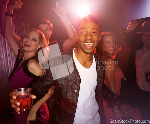 Image of Party, happy or friends in a club to dance in celebration of New Years or fun Birthday with black man or alcohol. Excited, diversity or happy people dancing to disco music at crazy social event night