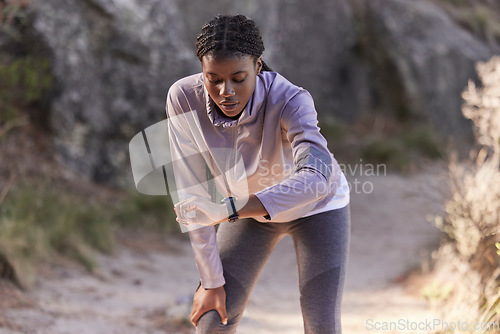 Image of Fitness, nature and woman with time on watch for running speed, progress check and steps monitor on smartwatch or digital technology. Runner, athlete or black woman in mountains training with a timer