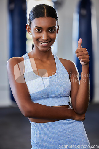 Image of Thumbs up, Indian woman and fitness, wellness and exercise health model with positive energy in gym. Motivation, encouragement and support for happy training workout, sports athlete and healthy goal