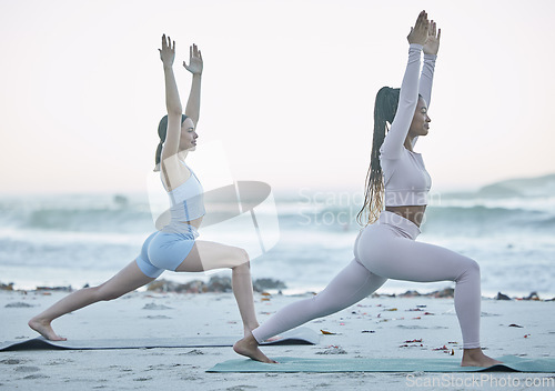 Image of Beach, fitness and yoga women or friends stretching for workout, exercise and training with ocean for peace, calm and zen. Pilates, cardio and accountability people with muscle and body health at sea