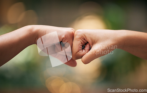 Image of Fist bump, friends and hands together for welcome with support, diversity and partnership collaboration. Bokeh background, racism and friendship goal welcome greeting collaboration outdoor with bokeh