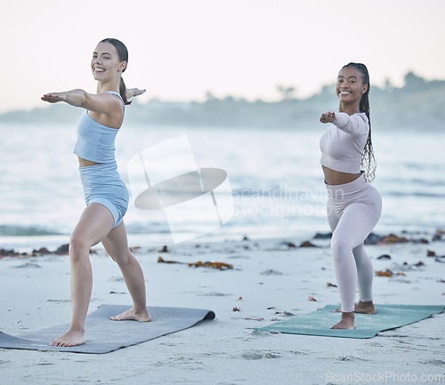 Image of Friends, yoga and stretching on the beach for health, wellness and body fitness by the ocean. Seaside, sport and active women yogi with friendship for active, fit and peaceful workout or exercise