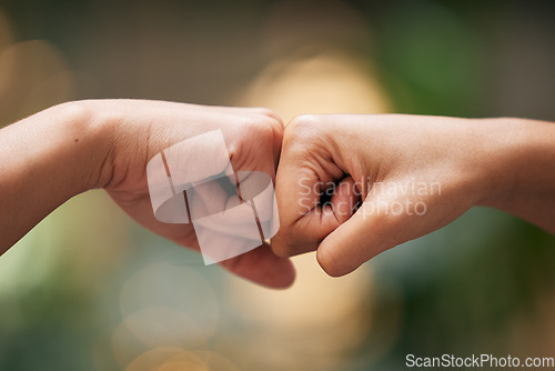 Image of Closeup fist bump, hands and greeting for friends, team or support for power, solidarity or touch. Hand connection, teamwork and motivation with knuckle, friendship and together by blurred background