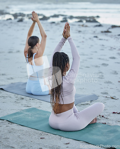 Image of Beach yoga, back of friends and women stretching outdoors for health, wellness and mobility. Zen chakra, meditation and hands up prayer pose with girls training for mindfulness, peace and wellness.