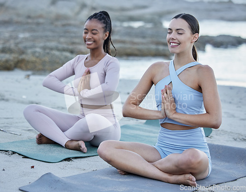 Image of Friends, yoga or meditation at beach, training and spiritual prayer, exercise or happy smile outdoor in nature. Diversity, pilates or workout at sea or ocean with calm mindset for health and wellness