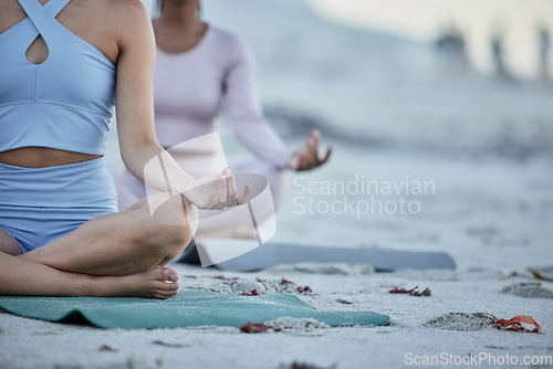 Image of Hands, yoga and friends on the beach for spiritual health and wellness workout or exercise. Training, friendship and yogi women meditating on yoga mats on the seaside sand for grattitude and mindset