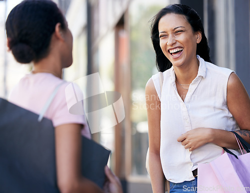 Image of Woman, friends and laughing with shopping bags for conversation, catch up or social communication in the outdoors. Happy women enjoying funny shopping spree, talking or speaking together about sales