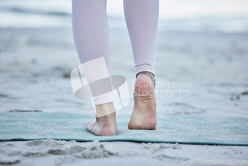 Image of Woman, bare feet and beach yoga exercise, workout and stretching ankle on sand for zen energy, healthy lifestyle or body wellness. Closeup, foot and fitness at ocean for pilates, balance and training