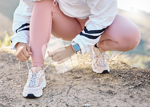 Image of Shoe, hand and woman tie lace for fitness, sport and run in nature for exercise and training workout. Athletic, athlete and footwear of a female sports runner prepare for running marathon outside