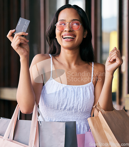 Image of Woman, credit card and smile for shopping with bags in happy marketing, ecommerce or buying at the mall. Portrait of female shopper smiling with bank card for luxury, payment or purchase for clothing