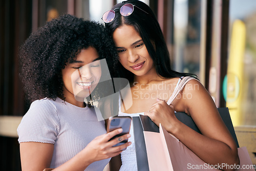 Image of Friends, phone and shopping at a mall while happy and reading bank notification for sale, savings and free gift while in city together. Females with smartphone for online customer promotion deals app