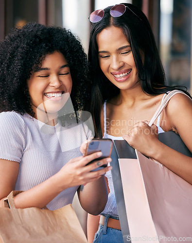 Image of Shopping, friends and women with phone in the mall enjoying freedom, quality time and weekend together. Shopping bags, smartphone and young girls laughing at meme online, social media and internet