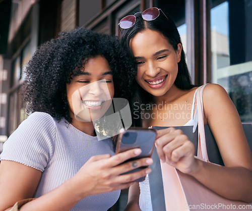 Image of Women, phone and online shopping in Cape Town street, read ecommerce website on retail shopping app in city. Happy friends, black woman and mobile tech, customer or promo notification on smartphone