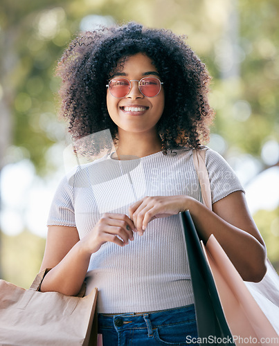 Image of Woman, shopping and bags outdoor for expensive purchase and buying items. Young black woman, customer or female shopper with clothes, boutique products and spending for retail therapy, smile or relax