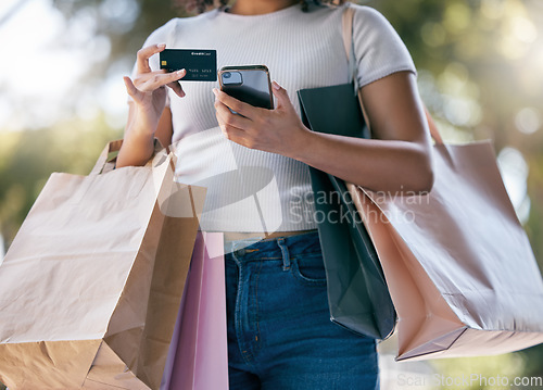 Image of Credit card, sale and phone with black woman, luxury boutique for customer or online purchase in city. Female customer, online payment or clothes in bag from retail gifts in town market trip in paris