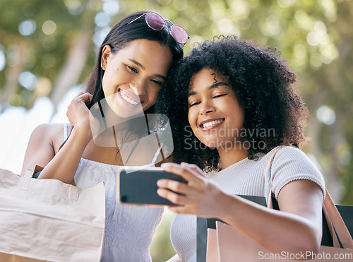 Image of Selfie, phone and friends shopping in the city for luxury retail discounts, sales or promotions. Happy, smile and women taking a picture together with a cellphone while buying clothes in a urban town