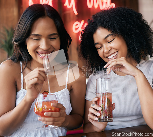 Image of Cocktail, drink and happy hour with black woman friends drinking in a club or bar together for fun. Cafe, glass and cocktails with a young female and best friend enjoying a beverage while bonding