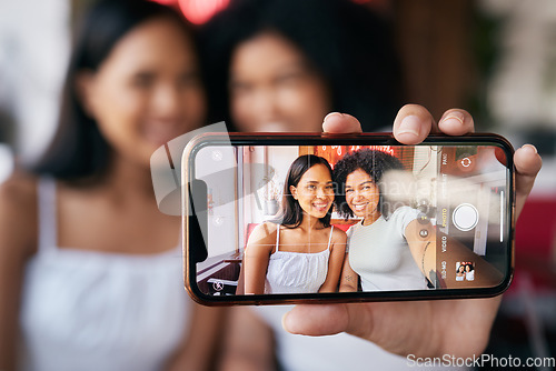 Image of Woman friends, selfie and phone screen for social media, blog post or bonding in restaurant. Happy black woman, influencer group and smartphone picture for social network, app or internet with smile