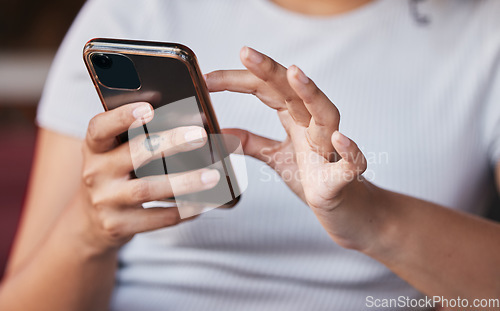 Image of Hands, phone and woman on social media in home, texting or internet browsing. Zoom, cellphone and female with mobile smartphone for messaging, networking on app or web scrolling on social network.