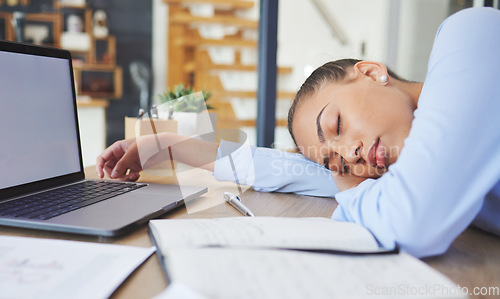 Image of Tired, exhausted and business woman sleeping at her desk while working in a modern office. Burnout, sleepy and professional corporate employee taking a nap while planning a project at her workplace.