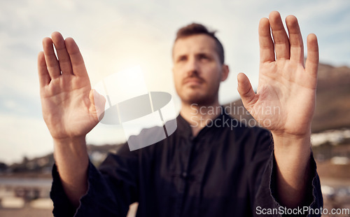 Image of Karate, martial arts and hands of man doing tai chi workout, balance training and sports exercise. Motivation, fitness and male athlete with focus for mindfulness, wellness and zen energy by sea