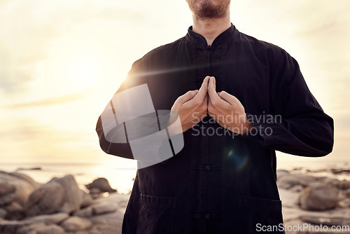 Image of Tai chi, martial arts and man with hands on beach for fitness and meditation, balance energy and healing at sunrise with self defense exercise. Calm, peace and zen outdoor, karate and wellness.
