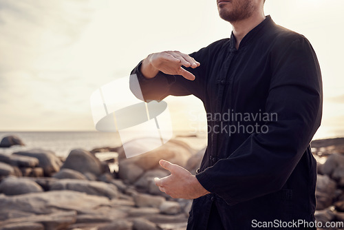 Image of Beach, peace and tai chi, man in nature for balance and peace for mental wellness or control of body and mind. Spiritual health, fitness and meditation, energy and self care on rocks at sea in sunset