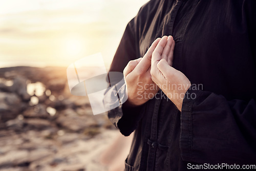 Image of Man, hands or tai chi on sunset beach for relax exercise, workout or training for mental health, chakra balance or mind wellness. Zoom, person or martial arts by sea, ocean or nature water at sunrise