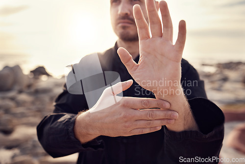 Image of Tai chi, hand and man on the beach practicing spiritual and meditation activity for peace and zen mind. Chi gong, gesture and male teacher for meditative sport and asian martial art exercise