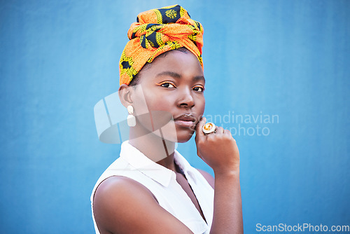 Image of Portrait, black woman and turban with makeup or relax on blue studio background. Nigerian female, girl or lady with traditional head wrap, natural beauty or cosmetics for smooth, clear skin or mockup