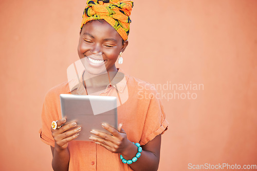 Image of Face, tablet and black woman on social media in studio on an orange mockup background. Tech, smile and happy female from Nigeria streaming video, movie or internet browsing on digital touchscreen.