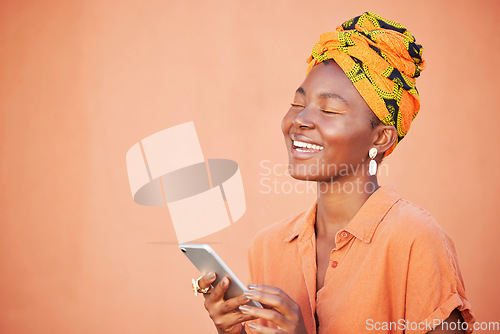 Image of Face, phone and black woman on social media in studio, texting or internet browsing on an orange mockup background. Comic, smile and happy female with mobile smartphone laughing at funny joke or meme