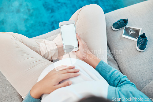 Image of Pregnant, woman and blank phone for social media sonogram post or announcement at home. Pregnancy, mother and internet communication about baby picture or ultrasound with shoes for media message