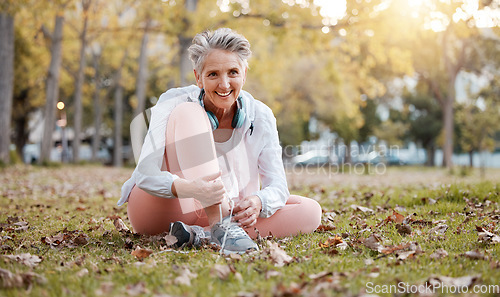 Image of Fitness, shoes and old woman in park for workout, cardio training or morning running. Happy senior female, fitness and tie sneakers on grass lawn to start exercise, healthy lifestyle or body wellness