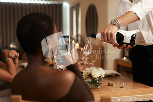 Image of Phone, black woman or hands pouring champagne at a New Years dinner party, Christmas or social event. Content creation, content creator or influencer live streaming drinks or alcohol in wine glass