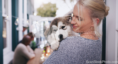 Image of Woman holding her dog with love, care and happiness at a dinner, party or celebration at a house. Happy, smile and lady hugging her husky pet at a festive, new year or christmas event at home.